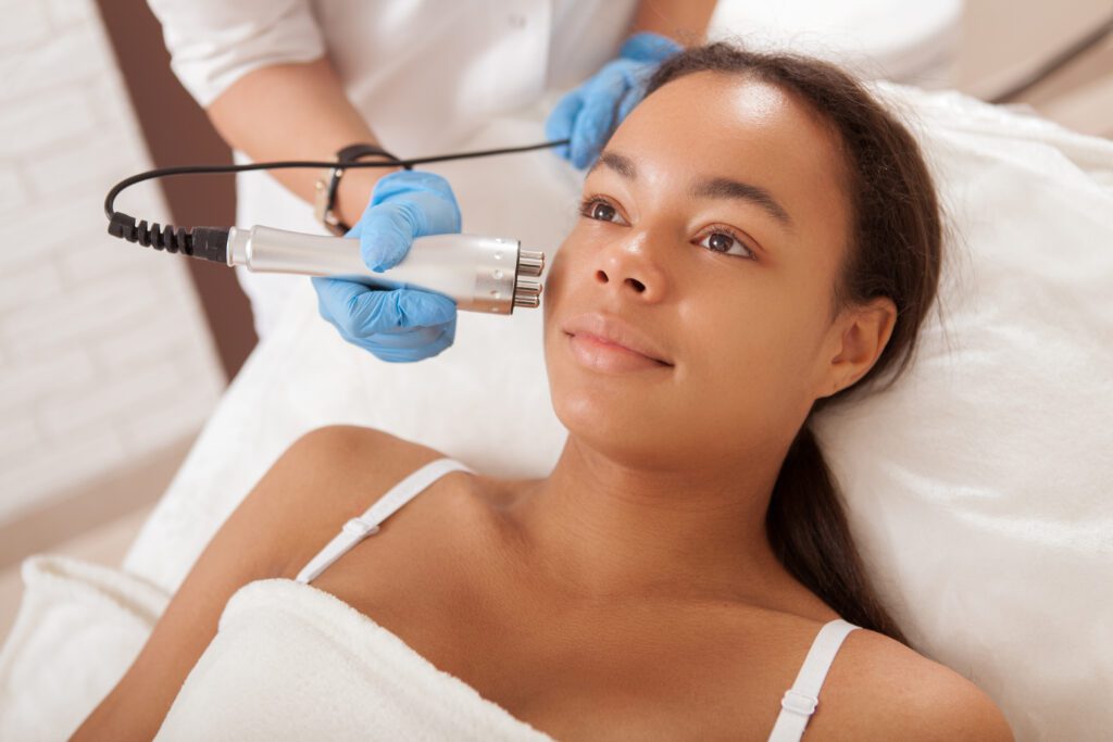 Happy,Beautiful,African,Woman,Smiling,While,Getting,Skin,Tightening,Treatment